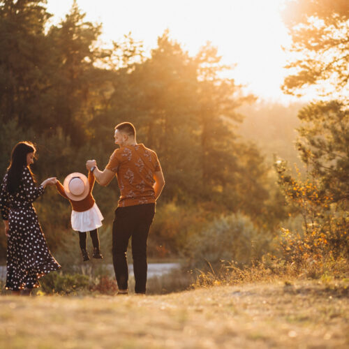 Family with their little daughter in an autumn field